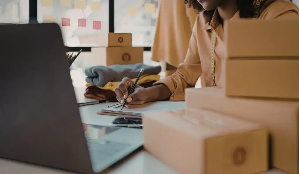 women writing on laptop about Order Fulfillment